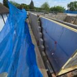 External insulation installation along façade with temporary protection