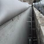 Brickwork cavity wall construction progressing up to parapet level on building elevation