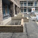 Blockwork wall construction progressing along building frontage