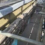 Brickwork cavity wall construction progressing at upper floor level with consistent brick bonding