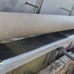 Fire stopping installation beneath coping detail at parapet level