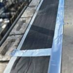 Fire stopping installation at parapet cavity closure detail