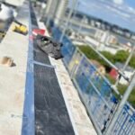 Fire stopping installation to parapet cavity closure along building edge