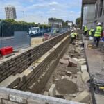 Foundation-level brickwork installation during early build stage