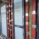 Professional fire stopping installation showing cavity barriers and fire-resistant materials fitted around window openings in accordance with UK fire safety regulations