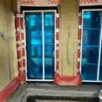 Completed insulation installation within the wall system, providing long-term thermal efficiency and regulatory compliance.