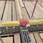 Insulation installed within cavity at structural junction