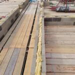 Insulation installation along wall cavity with continuous thermal layer