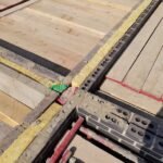 Full-fill cavity insulation installed at floor junction to maintain thermal continuity