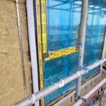 Insulation installation around window opening with airtight detailing