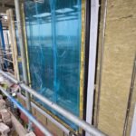 Insulation boards fitted around full-height window opening