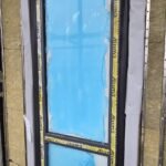 Insulation boards fitted around window frame within cavity wall