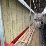 Insulation boards installed vertically within cavity wall system