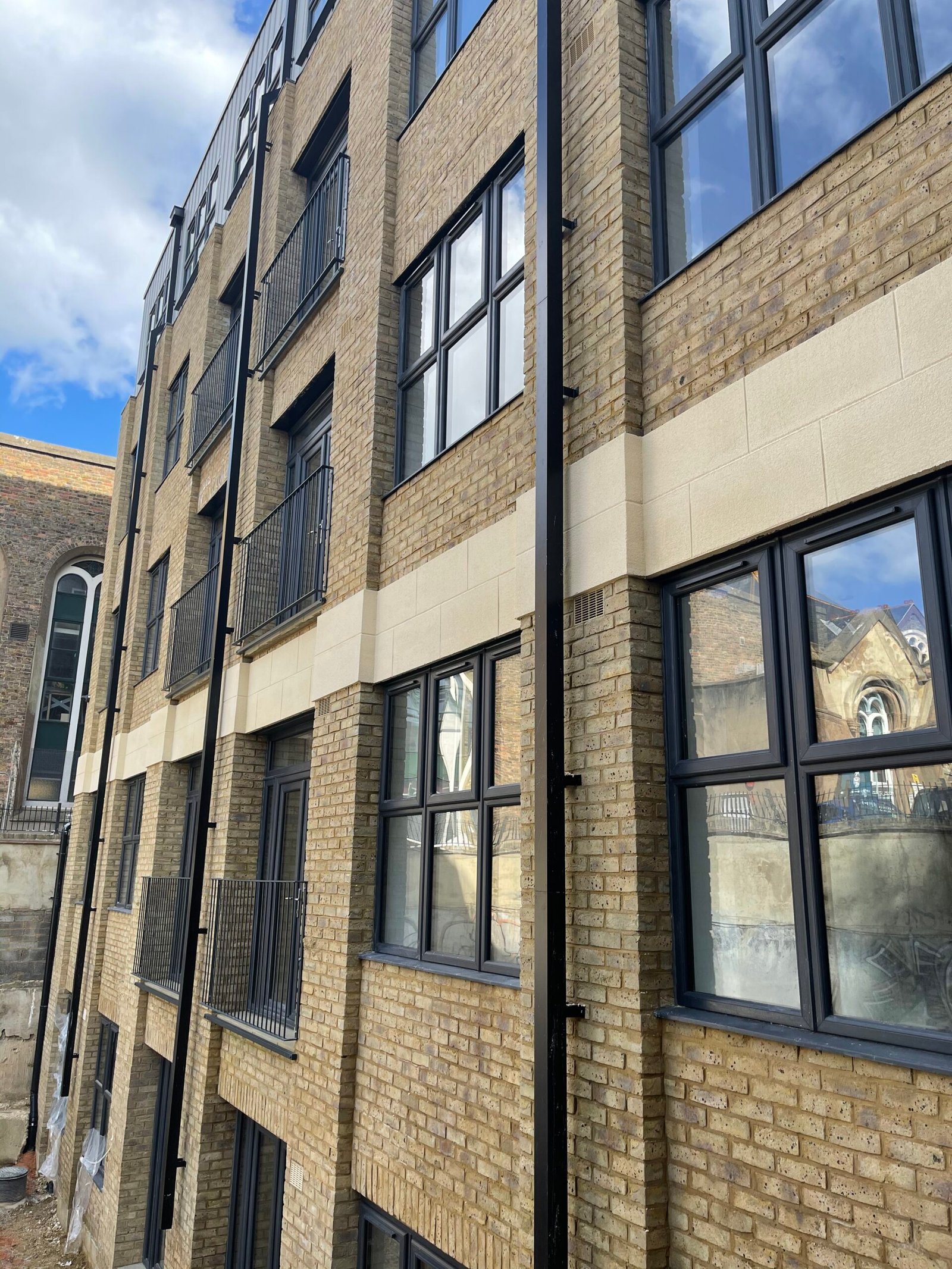 High-quality brickwork installation on modern apartment building exterior completed by New Era Brickwork