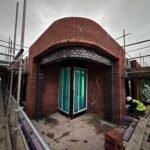 Curved brick arch construction using traditional masonry techniques