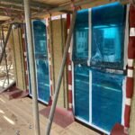 Insulation installation progressing across ground floor elevation